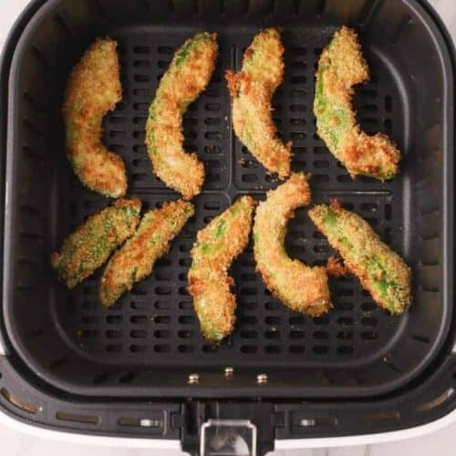 Cooked avocado fries in air fryer basket