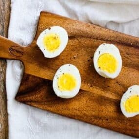 Hard-Boiled Air Fried Eggs on a small wooden cutting board