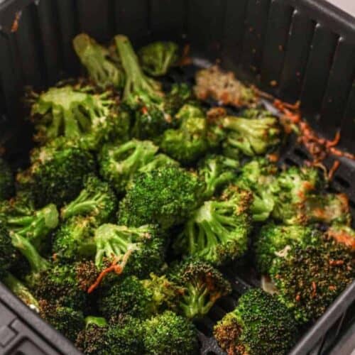 Roasted broccoli in air fryer basket cooked