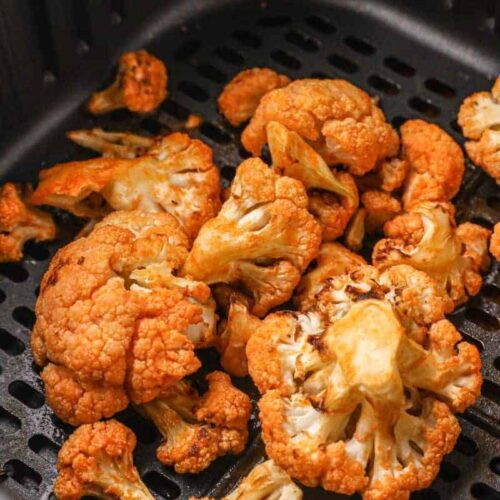 Closeup of buffalo cauliflower in air fryer basket