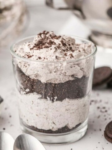 Glass filled with oreo mousse with oreo crumbs on top