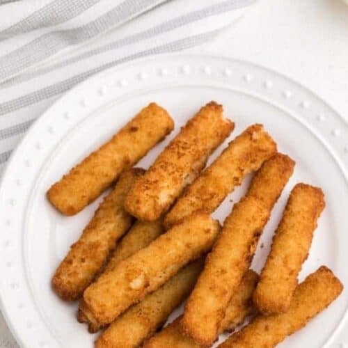 Frozen Air Fryer Fish Sticks on a white plate