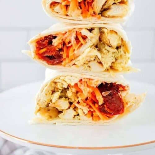 Pesto Chicken Wrap stacked on top of each other on a white plate