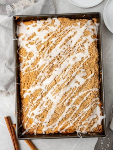 Baked coffee cake in a 13x9 pan topped with icing glaze