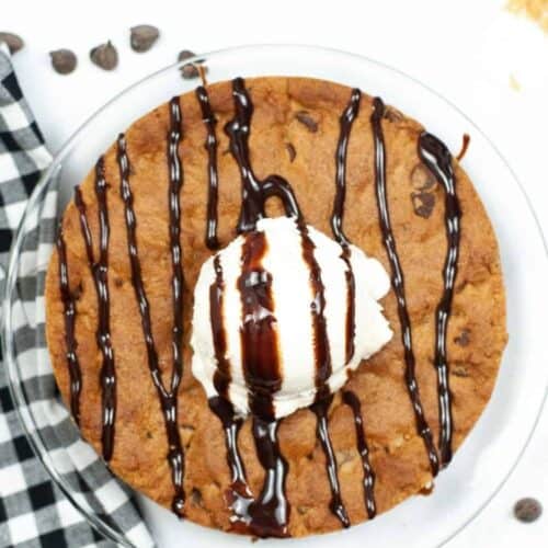 Air Fryer Cookie Cake for One from overhead with ice cream anf syrup drizzled on top