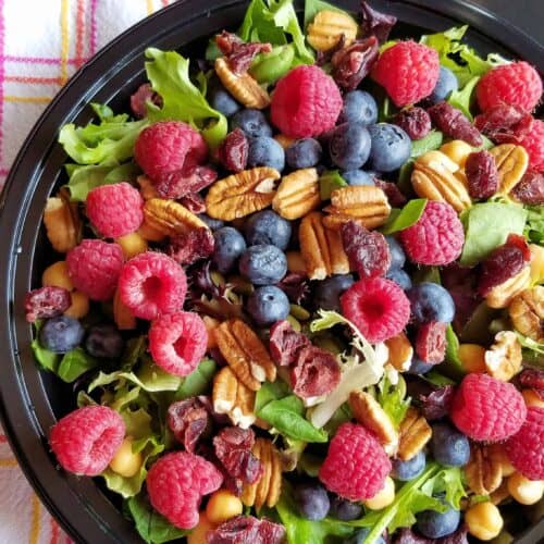 Easy lunch idea of berry salad served in a black bowl.