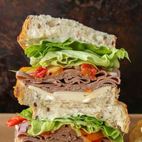 Roast beef sandwich cut in half and stacked on top of each other.