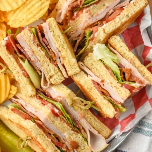 Club sandwiches cut into quarters so you can see inside them.