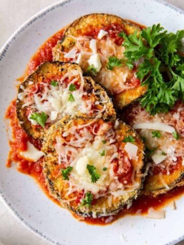 Air Fryer Eggplant Parm cutlets on a white plate