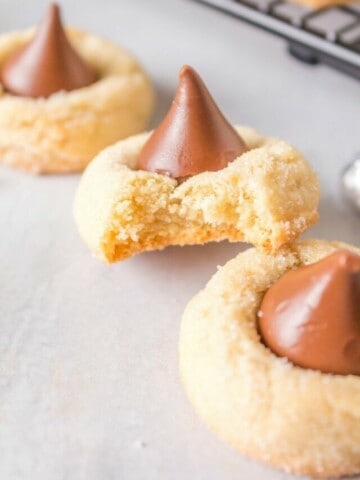 Hershey Kiss Cookies with shortbread with one bitten into so you can see the inside of the soft chewy cookie