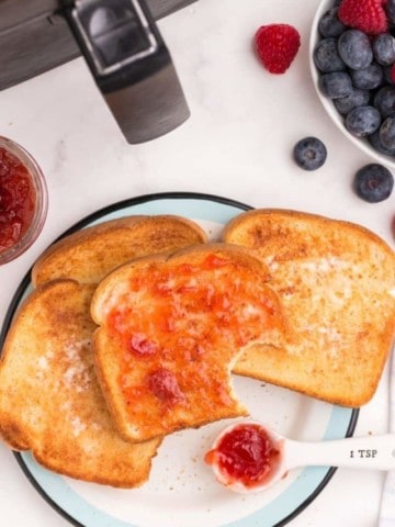 Slices of air fryer toast with jam on a plate