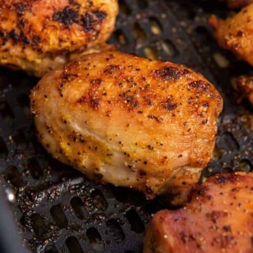 zoom in on cooked and seasoned chicken thigh in air fryer