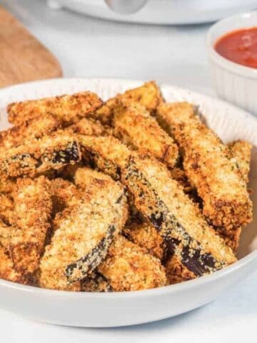 Full plate of breaded eggplant fries from air fryer