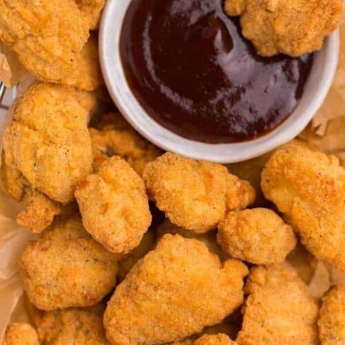 Crunchy popcorn chicken bites with bbq sauce on the side