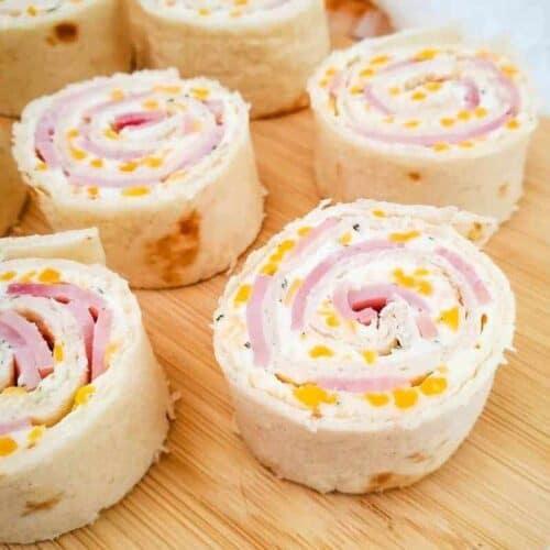 Ham and cheese roll-ups displayed on cutting board