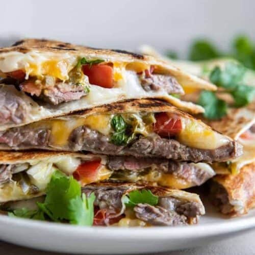 Stack of carne asada quesadillas on plate