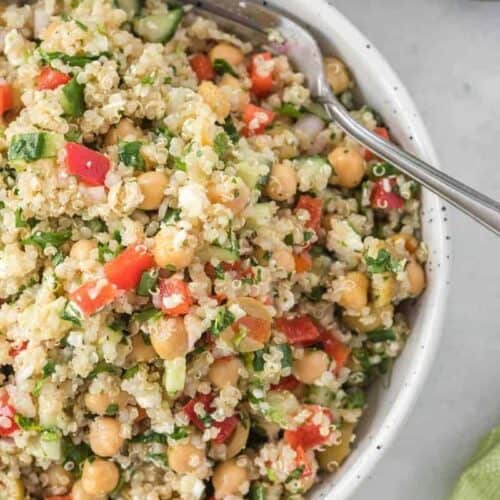 close of white salad bowl full of quinoa salad