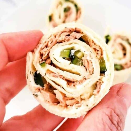 Slice of tuna pinwheel held in a hand