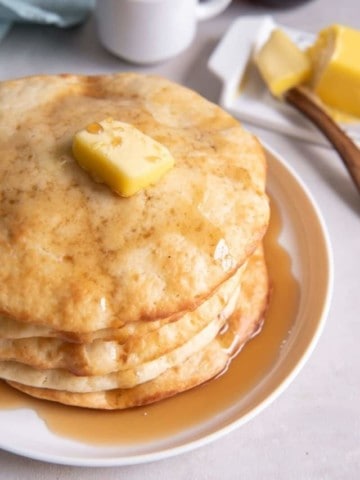 stack of air fryer pancakes with syrup drizzled on top