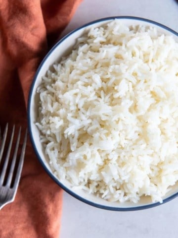 aerial shot of bowl of air fryer rice with fork on table