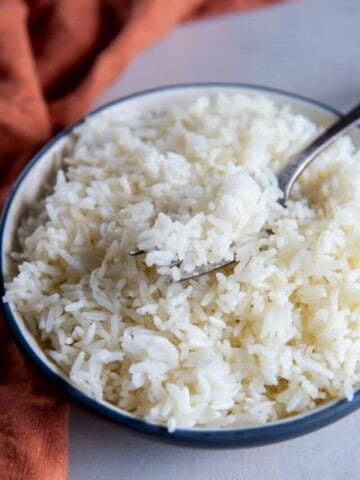 Air fryer rice in white bowl with fork