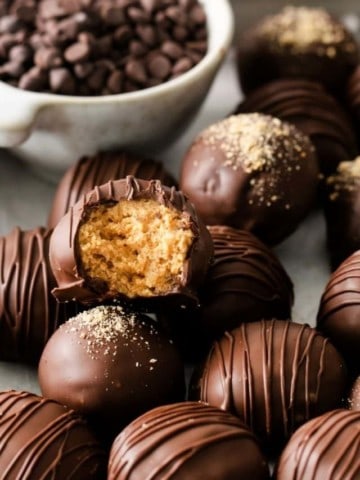 Pile of peanut butter balls and the top one has a bite taken out of it