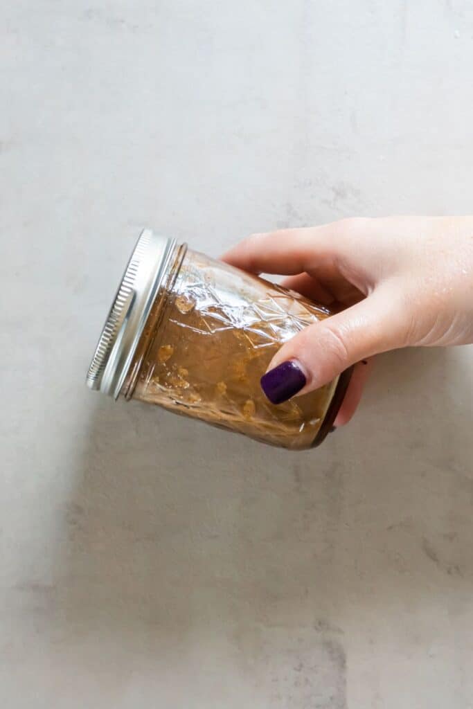 Shaking up the stir fry sauce in a mason jar.