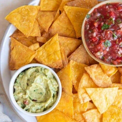 Homemade air fryer tortilla chips with guacamole and salsa