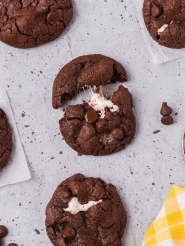 chocolate cookie with marshmallows being pulled apart