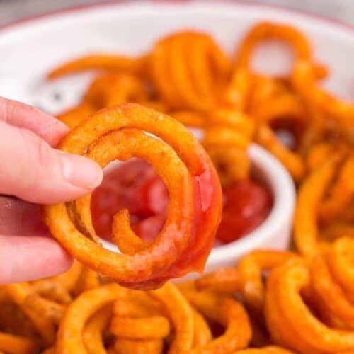 curly fry being dipped in sauce