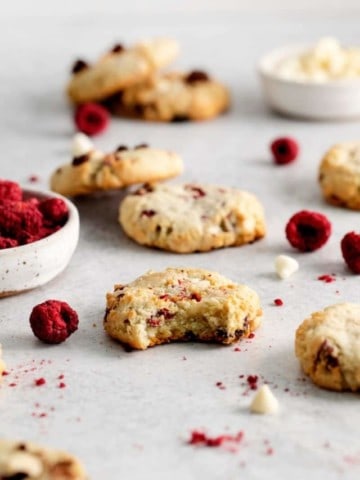 raspberry cheesecake cookies with a bite out of one