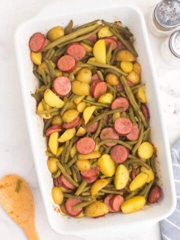 green beans, sausage, and potatoes in a casserole dish