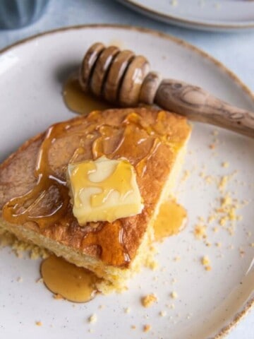 closeup of honey drizzled on a piece of cornbread