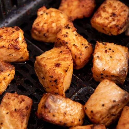 Closeup of salmon chunks in air fryer