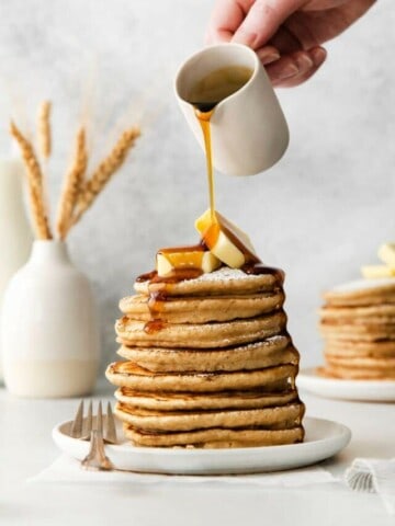 pouring syrup on pancakes