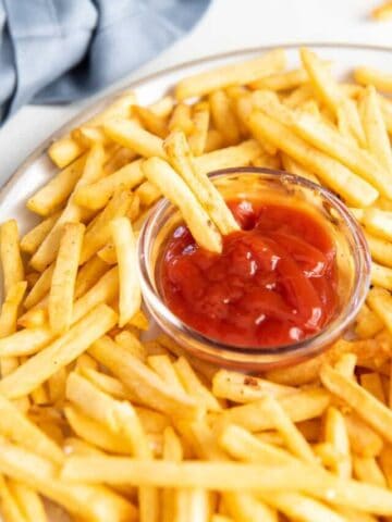 dipping fries into ketchup