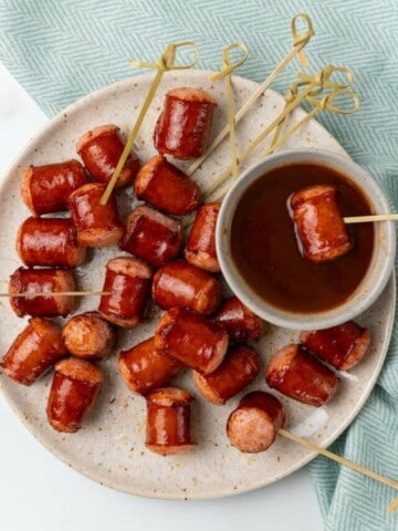 dipping smoked sausage into sauce