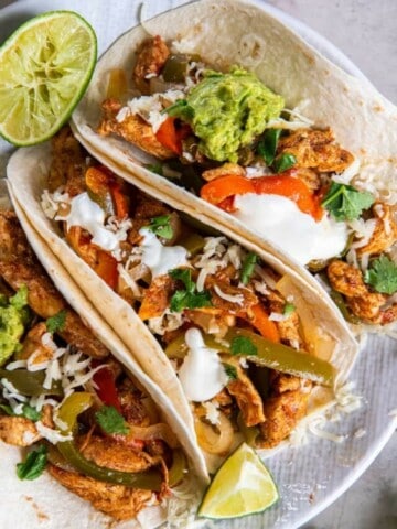 3 Chicken Fajitas on a white plate.