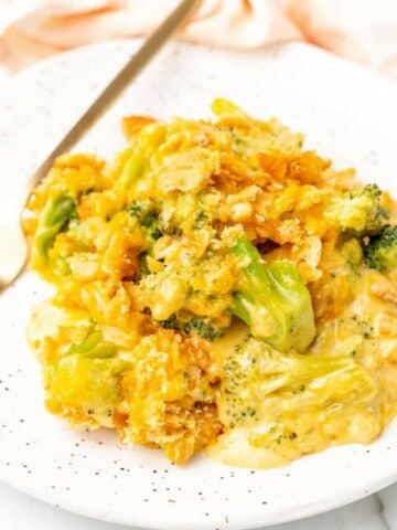 A serving of broccoli casserole on a white plate.