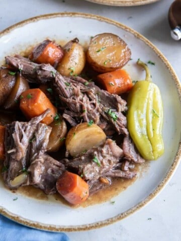 A close up view of prepared and plated Mississippi Pot Roast with Vegetables.