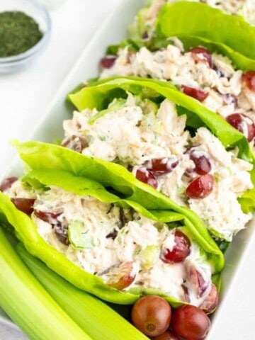 Chicken salad being served in lettuce as wraps.