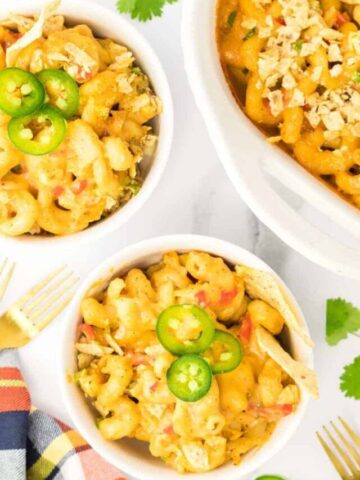 overhead shot of mexican mac and cheese in bowls and casserole dish.