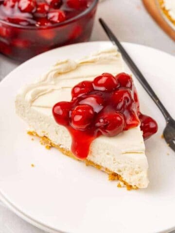 overhead shot of no bake cheesecake slice with cherry topping