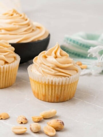 Close up shot of vanilla cake frosted with creamy peanut butter cream cheese icing.