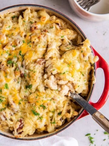 using a slotted spoon to serve homemade mac and cheese