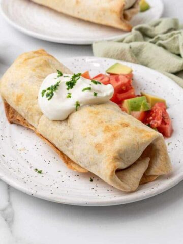 Mexican air fryer chimichangas served on a plate.