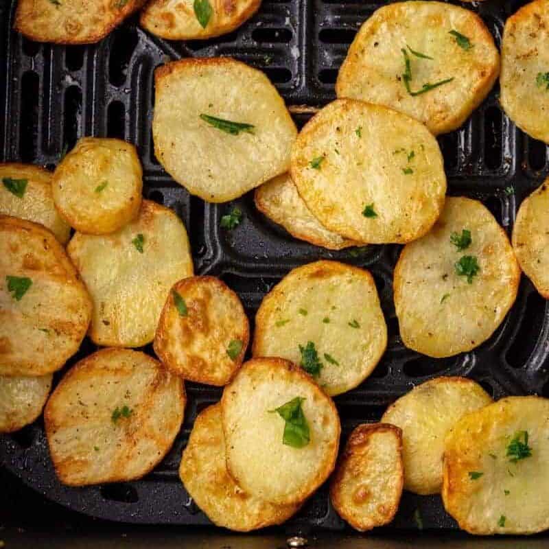 Air fryer sliced potatoes in air fryer basket