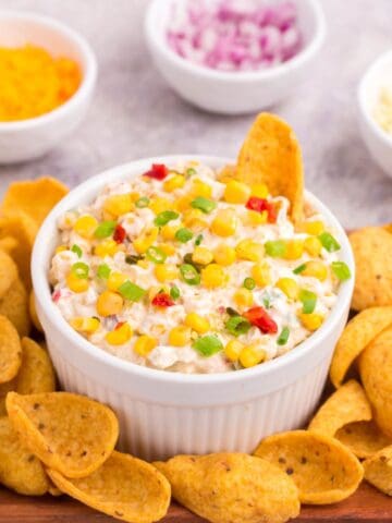 a bowl of fiesta corn dip with scoopable Frito chips