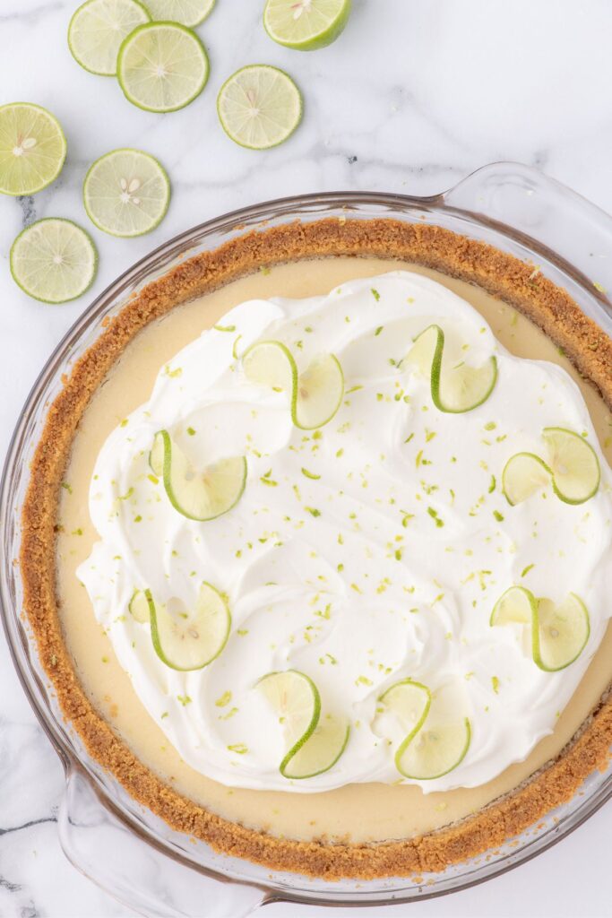 homemade key lime pie with whipped cream and lime zest