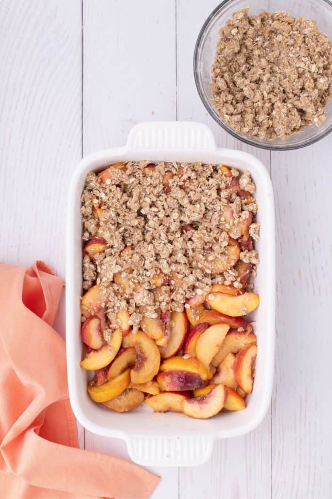 add butter oat crumble on top of sugared peaches